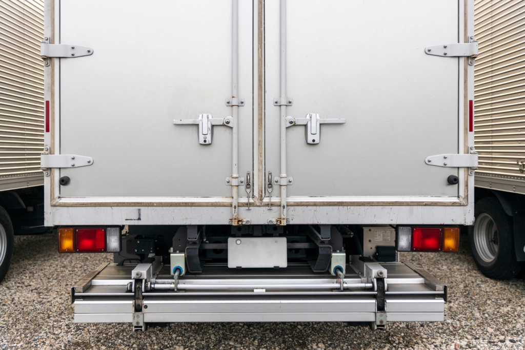 Closed rear doors of parked shipping truck with blank license plate