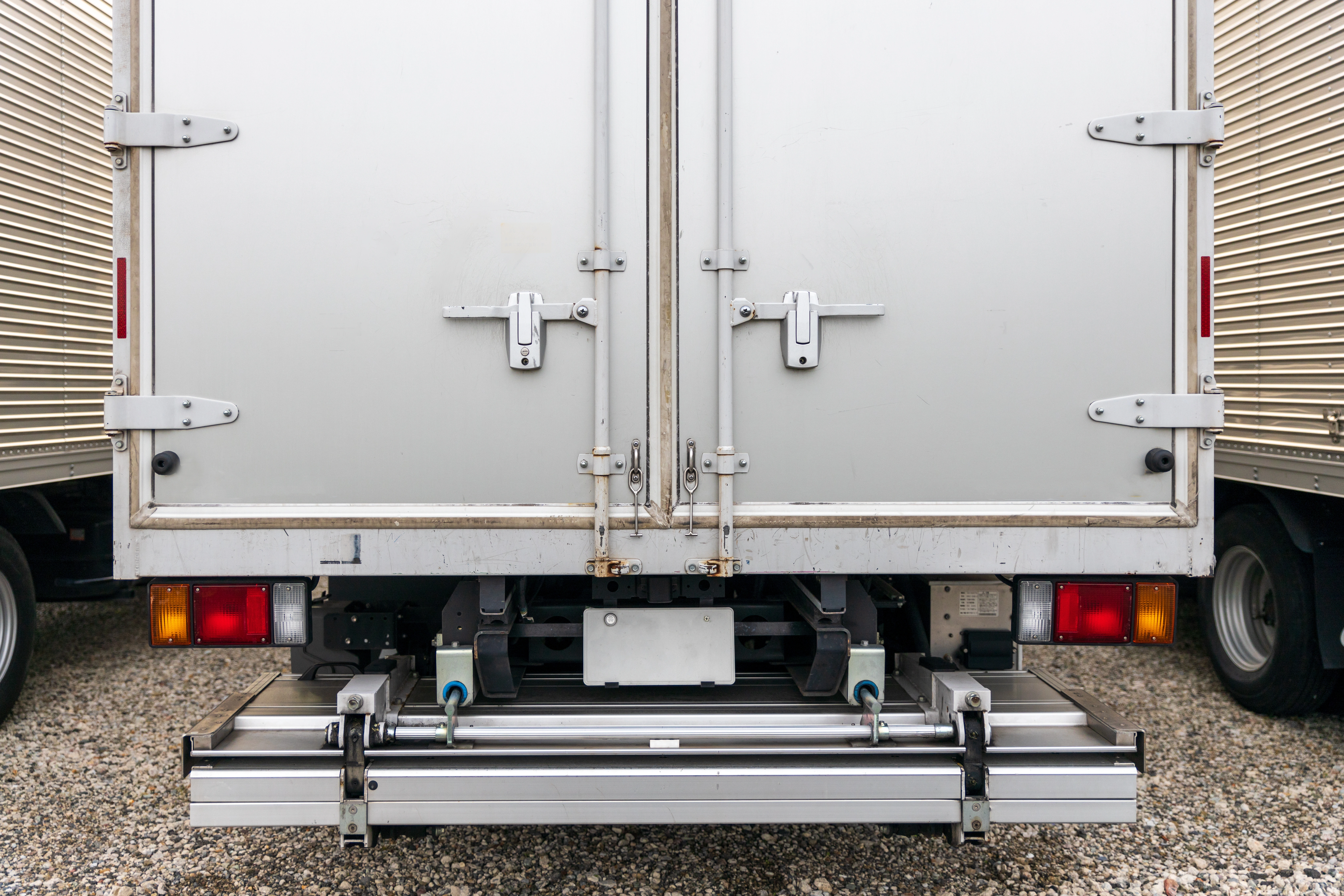 Closed rear doors of parked shipping truck with blank license plate